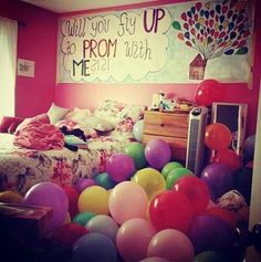 a bedroom with balloons all over the floor and a sign on the wall that says, what you say up to prom with me