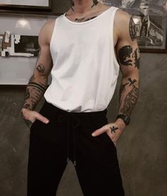 a man with tattoos on his arms and chest