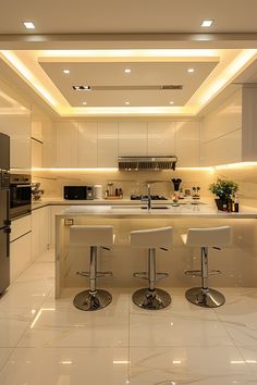 a kitchen with two stools in front of the counter and an oven on the other side