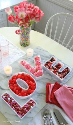 valentine's day table setting with candy and flowers