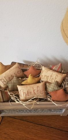 a tray filled with decorative pillows on top of a wooden table