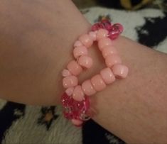 a close up of a person's arm wearing a bracelet with beads on it