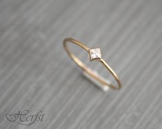 a diamond ring sitting on top of a wooden table