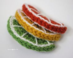 four crocheted pieces of yarn sitting on top of each other