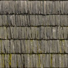 the roof of a building with moss growing on it's shingles and wood slats