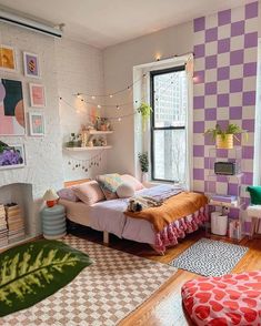 a bedroom with purple and white checkered walls, a bed in the corner, rugs on the floor