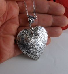 Hand-painted antique silver heart-shaped locket 42 mm.   Decorated with a cute antique silver butterfly and is hand-painted black.  Hanging from a silver chain and lobster clasp. The locket has room for two photos inside!   Thanks for looking:) ~Mani Victorian Silver Jewelry For Valentine's Day, Antique Silver Heart-shaped Nickel-free Jewelry, Silver Butterfly Jewelry For Wedding, Vintage Silver Jewelry With Butterfly Charm, Antique Silver Heart-shaped Jewelry Gift, Vintage Butterfly Jewelry For Wedding, Handmade Heart-shaped Antique Silver Jewelry, Handmade Antique Silver Heart Jewelry, Silver Double Heart Jewelry For Wedding Gift