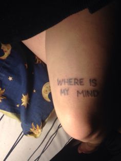 a person with a tattoo that says where is my mind? on their left side