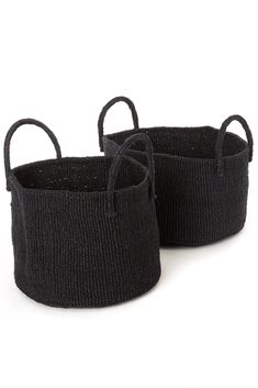 two black woven baskets with handles on white background