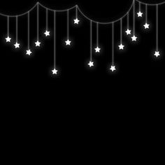 a black background with white stars hanging from the ceiling