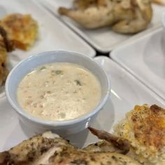 four plates with different types of food on them, including chicken wings and dipping sauce