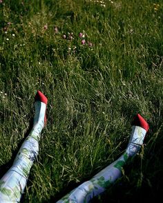 someone's feet in the grass with their socks on