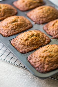 freshly baked muffins in a baking pan on a cooling rack, ready to be eaten