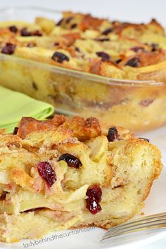 a white plate topped with a casserole covered in cranberry toppings