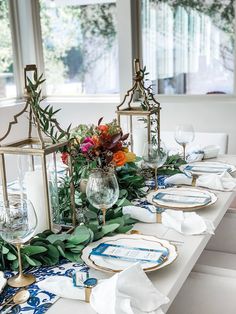 a long table with plates and place settings on it