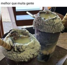 two glasses filled with ice cream sitting on top of a table