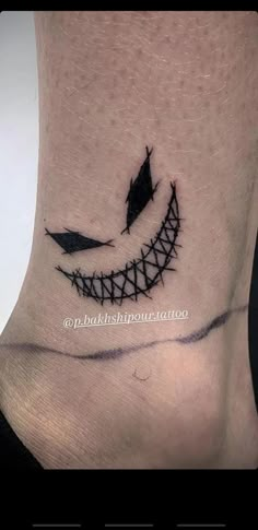 a black and white image of a smile on the ankle