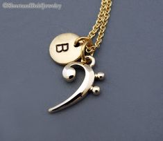 "❖ Bass clef charm in gold plated. Approx: 5/8 X 7/16\" ❖ Hand Stamped Initial Charm - Antique Gold Pewter 3/8\" (9mm) ❖ Click below for Bass clef in silver plated: https://www.etsy.com/listing/191672080 ❖ Add a birthstone or Freshwater pearl for $3.50 https://www.etsy.com/listing/110444872 ❖ Additional Hand Stamped Initial Charms $4.50 each: https://www.etsy.com/listing/107021419 ❖ Go back to Short and Bald Jewelry http://www.etsy.com/shop/ShortandBaldJewelry ❖ Your purchase will arrive attract Personalized Gold Music-themed Jewelry, Base Clef, Black Cat Necklace, Bass Clef, Cat Charm, Cat Necklace, Losing A Pet, Cute Necklace, Personalized Monogram