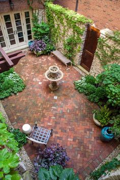 an aerial view of a brick patio and garden