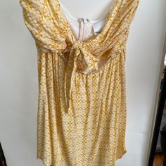 Yellow Cutout Sundress. Beautiful Pattern With Tie Top. Never Worn. Bought From Grey Bandit Yellow Sundress With Tie Back, Yellow Tie Back Sundress, Summer Mini Dress With Tie Back For Daytime, Sleeveless Mini Dress With Tie Back For Daytime, Yellow Printed Sundress, Yellow Mini Dress With Tie Back For Brunch, Yellow Tie Back Mini Dress For Vacation, Cutout Sundress, Yellow Tie Back Mini Dress For Beach