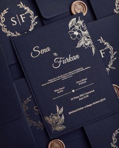 the wedding stationery is made up of navy blue paper with gold foiling and embellishments