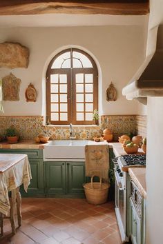 a kitchen with green cabinets and tile flooring