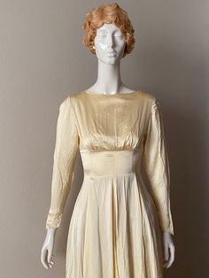 a white mannequin wearing a yellow dress