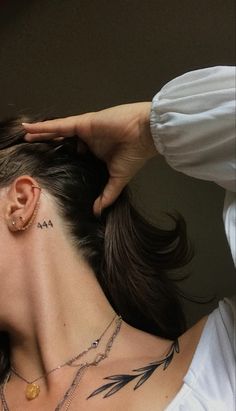 a woman with a tattoo on her neck