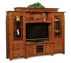 a wooden entertainment center with a flat screen tv on it's side and shelves