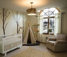 a baby's room with a teepee tent in the corner