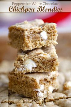 three pieces of white chocolate chickpea blondies stacked on top of each other