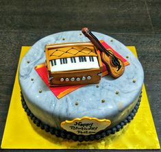 a birthday cake with a musical instrument on top