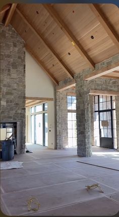 an empty room with stone pillars and windows