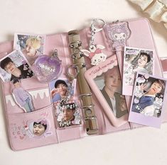 a pink purse with pictures and keychains on it