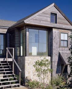 an exterior view of a house with stairs leading up to it