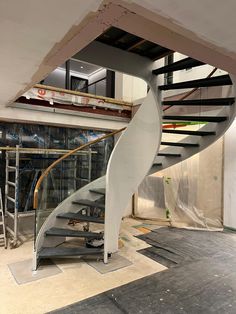 a white spiral staircase in a building under construction