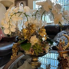 a glass table with flowers on it in a living room