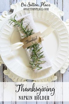 a white plate topped with napkins covered in greenery