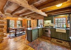 a rustic kitchen with green cabinets and wood flooring is seen in this image from the inside