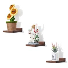 three small pots with plants and stuffed animals on them