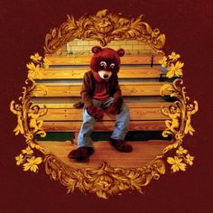 the college dropout poster with a teddy bear sitting on a bench in front of it