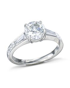 a diamond ring with baguets on the side