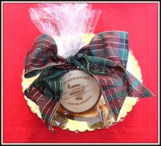 a small basket filled with cookies on top of a red cloth covered table next to a plastic bag