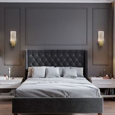 a large bed sitting next to two nightstands on either side of the bed in front of a gray wall