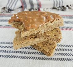 three pieces of food sitting on top of a white and blue table cloth next to each other