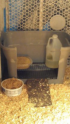 a tub filled with lots of food next to two buckets