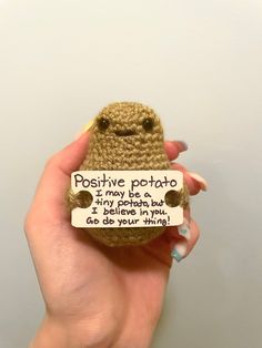 a person holding a small stuffed animal that says positive potato i may be a bug, i believe in you, go do your thing