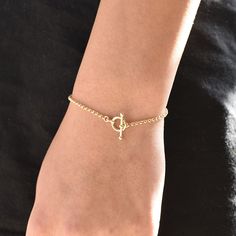 "14K GoldToggle Rolo Chain Bracelet - 14K Gold 2mm Rolo Chain Bracelet ★ 14K gold 2mm rolo chain ★ 14K gold toggle clasp ★ All components are 14K solid yellow gold The length includes the chain and the closure. Please measure your wrist before you place your order. ** How to choose a correct size of bracelet. 1. Measure your wrist below the wrist bone using a flexible tape measures, a string or a strip of paper. 2. If using a string or a strip of paper, mark length. Then, measure it with a ruler Classic Gold Chain Bracelet With Rolo Chain, Yellow Gold Plated Bracelet With Toggle Clasp, Elegant Gold Bracelets With Rolo Chain, Yellow Gold-plated Bracelet With Toggle Clasp, Classic Gold-tone Bracelets With Toggle Clasp, Yellow Gold Bracelet With Toggle Clasp, Gold Chain Bracelet For Everyday, Elegant Adjustable Rolo Chain Bracelet, Yellow Gold Chain Bracelet With Spring Ring Clasp