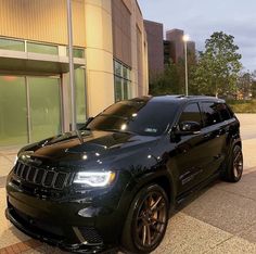 a black jeep parked in front of a building