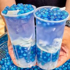 two plastic cups filled with blue candy